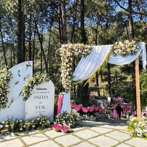 Grand royal wedding stage with white floral backdrops and golden seating